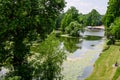 Vivid landscape in Nicolae Romaescu park from Craiova in Dolj county, Romania, with lake, waterlillies and large green tres in a