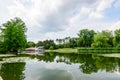 Vivid landscape in Nicolae Romaescu park from Craiova in Dolj county, Romania, with lake, waterlillies and large green tres in a