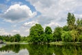 Vivid landscape in Nicolae Romaescu park from Craiova in Dolj county, Romania, with lake, waterlillies and large green tres in a