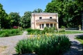 Vivid landscape in Nicolae Romaescu park from Craiova in Dolj county, Romania, with an old house, yellow iris flowes and large