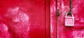 Vivid pink padlock hanging on rusty garage door. Unlock data, safe information concept. Love and relationship concept Royalty Free Stock Photo