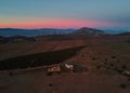 Vivid pink sunset over farmland cultivated land