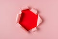 Vivid pink torn paper with burst hole background. Minimal abstract concept