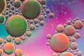 Vivid purple, pink, orange and green psychedelic abstract giving the impression of planets