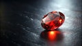 A vivid red gemstone resting on a dark, smooth surface, reflecting light. Generative AI Royalty Free Stock Photo