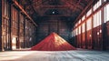 A vivid red pile of sand stands out in a vast warehouse, showcasing the mining and processing of potash fertilizers in action