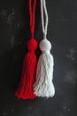 Vivid red and pure white Martisor tassels against dark textured grunge background. Moldavian, Romanian tradition 1 March Royalty Free Stock Photo