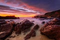 Vivid red sunrise over rocky beach coast Royalty Free Stock Photo