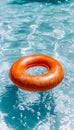 Vivid red swim ring floating in the crystal clear water of a refreshing swimming pool Royalty Free Stock Photo