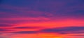 Vivid saturated beautiful sunset sky in orange, purple and red colors. Sunset background Royalty Free Stock Photo