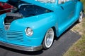 Vivid sky blue antique vintage convertible automobile with top down and open hood at a car show in Minnesota in bright sunlight. I Royalty Free Stock Photo