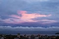 Vivid sky of pink and blue colors during sundown. Beautiful skyscape with clouds at the sunset time over a seaside city. Evening Royalty Free Stock Photo