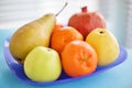 Vivid still life with fruits on blue plate Royalty Free Stock Photo