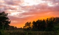 Vivid sunset in a moorland landscape, sundown giving a colorful effect in the sky and clouds Royalty Free Stock Photo