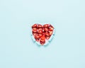 Vivid torn paper heart on bright background. Minimal love or like concept. Flat lay