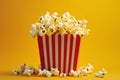 Vivid yellow background, red and white striped popcorn box, cheerful movie-watching experience