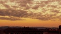 Vivid yellow orange sunrise sunset over the town of Bansko Pirin Bulgaria and the mountains. Royalty Free Stock Photo