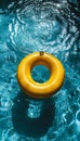 Vivid yellow pool float ring drifting in serene water of a shimmering blue swimming pool Royalty Free Stock Photo