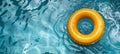 Vivid yellow pool float ring gently floating in the sparkling azure swimming pool Royalty Free Stock Photo