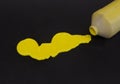 Vivid yellow Tempera Paint Spilled on Black Background Royalty Free Stock Photo