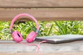 Vividl pink headphones and laptop