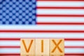 vix index usa. wooden blocks with the inscription vix on the background of the usa flag.