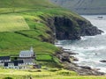 ViÃÂ°oy, ViÃÂ°areiÃÂ°i, view on the church and part of the town. In the background cliffs and ocean