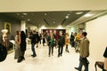 Famous people in the art gallery. Vintage exhibition of women`s clothing and hats. The exhibition has many journalists who take pi