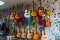 Vladikavkaz, Russia, 23 December 2019 - a lot of acoustic guitars and ukuleles hang on the wall in a music store Royalty Free Stock Photo