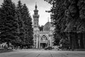 Vladikavkaz, Russia - 07 18 2019: People having rest on the square among beautiful old pine trees in front of Sunni