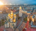 Vladimir Cathedral with golden shine domes and a bell tower in the city of St. Petersburg, aerial height view at evening sunset Royalty Free Stock Photo