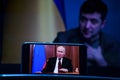 Vladimir Putin speech on TV. Volodymyr Zelensky the president of Ukraine in the background . Volodymyr Zelenskyy speech to people