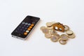 Vladimir, Russia -January 2022: Wooden small house among the coins next to the calculator.