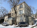 Vladivostok, Russia, February, 29,2020. Cars are parked at an old house on Pushkinskaya street in the center of Vladivostok