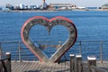 Urban landscape with a metal heart on the background of the sea