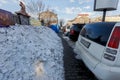 Vladivostok, Russia, 2017 - Dirty street in Vladivostok. Cars are parked in front of large muddy snow drifts on the streets of