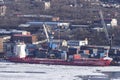 Ice-covered container ships loading at the pier at the port in the Golden Horn Bay Royalty Free Stock Photo