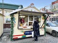 Vladivostok, Russia, January, 14,2022. Woman at the trade pavilion at the winter fair `Made in Primorye` on Admirala Fokina Street Royalty Free Stock Photo