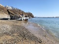 Vladivostok, Russia, March, 13,2020. Old abandoned small boat on the shore of Patrokl Bay. Vladivostok, Russia