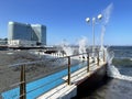 Vladivostok, Russia, October, 10, 2023. Waves on the Sports embankment against the background of the Barny apart-hotel