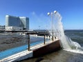 Vladivostok, Russia, October, 10, 2023. Waves on the Sports embankment against the background of the Barny apart-hotel