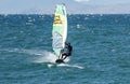 Windsurfers on the waves of the Amur Bay on a cold windy autumn day