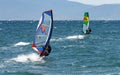 Windsurfers on the waves of the Amur Bay on a cold windy autumn day