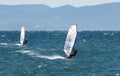 Windsurfers on the waves of the Amur Bay on a cold windy autumn day