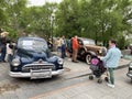 Vladivostok, Russia, May, 18, 2019. People walking on Exhibition of American retro-cars near Buick Road Master 1950 year and Dodge