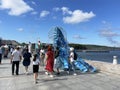 Vladivostok, Russia, September, 15,09, 2023. People walking ner Octopus sculpture on the FEFU embankment