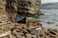 Wooden North Korean fishing boats thrown by a storm onto a rocky shore near Vladivostok