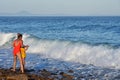 Vladivostok, Russia, July, 21, 2020. Woman with a child looking for large wave in sea of Japan