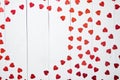 Vlentine`s Day composition. Heart shaped sequins placed on white wooden table