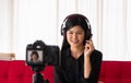 Vlog Asian woman blogger influencer sitting on the sofa in home and recording video blog for teaching and coach her Students or Royalty Free Stock Photo